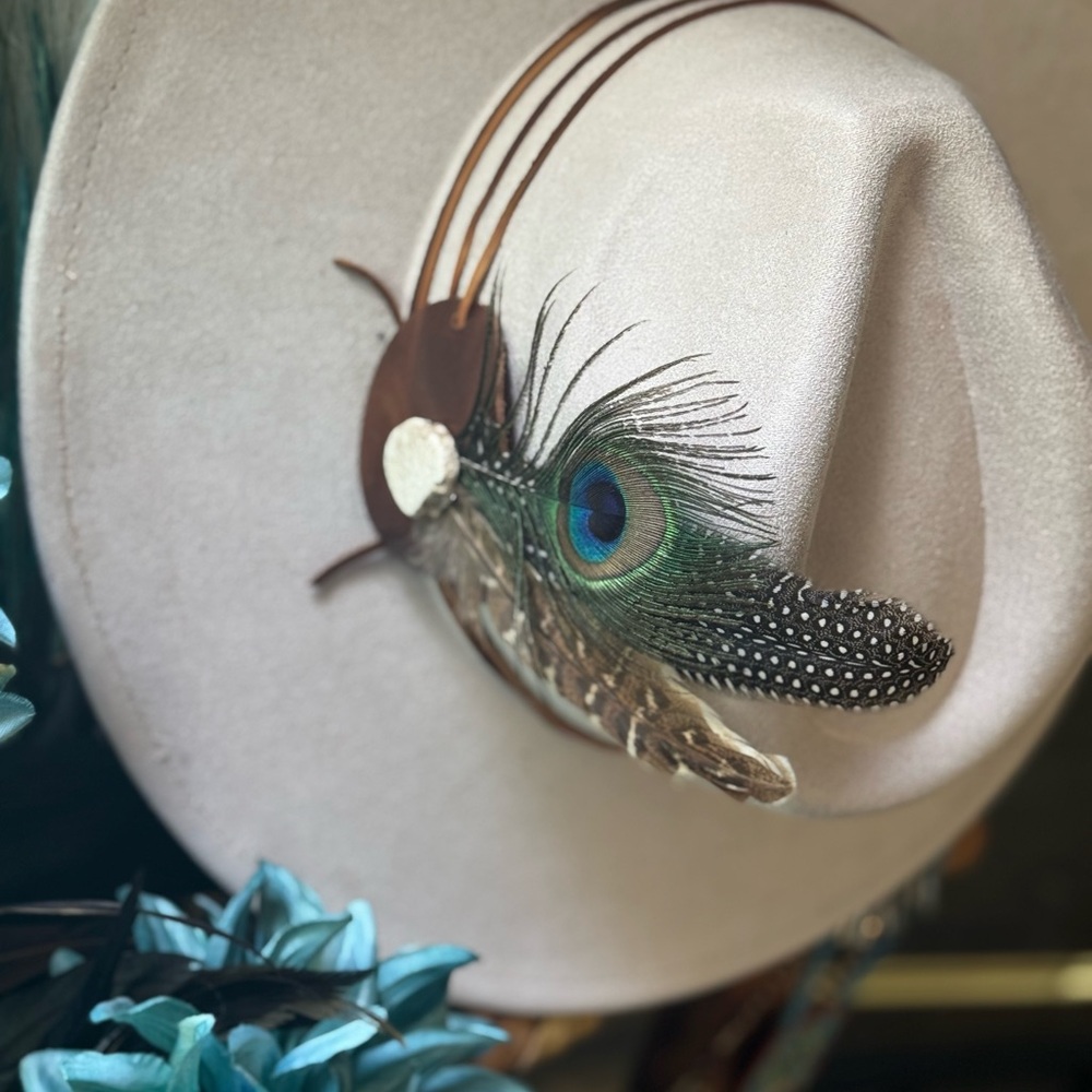 Flat brim cream hat with leather wrapped band.